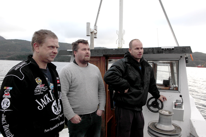 Som David mot Goliat: Fra venstre Arve Hersdal, Sigbjørn Langhelle og Kjell Inge Kvamen titter bort på Statfjord C lastebøye som lå oppankret i Yrkefjorden før den skulle hogges opp på anlegget.