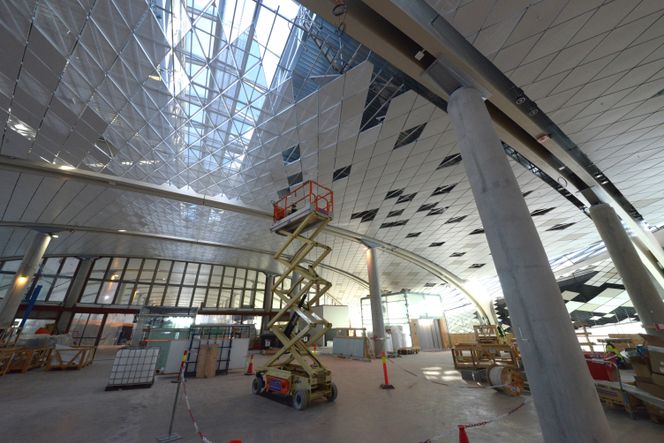 Pir Nord er i likhet med resten av flyplassen tegnet av arkitektkontoret Nordic. Stikkord for valg av takkledning er beskyttelse, uv og drift. Ved utbytting skal to mann kunne demontere elementene. De utgjør også et arkitektonisk virkemiddel som understreker pirens form og retning. De trigonometriske takelementene er levert av Lett-Tak som er underleverandør til Kruse Smith i gruppen med ansvar for fasaden. Foto: Fredrik Drevon. Foto: Fredrik Drevon