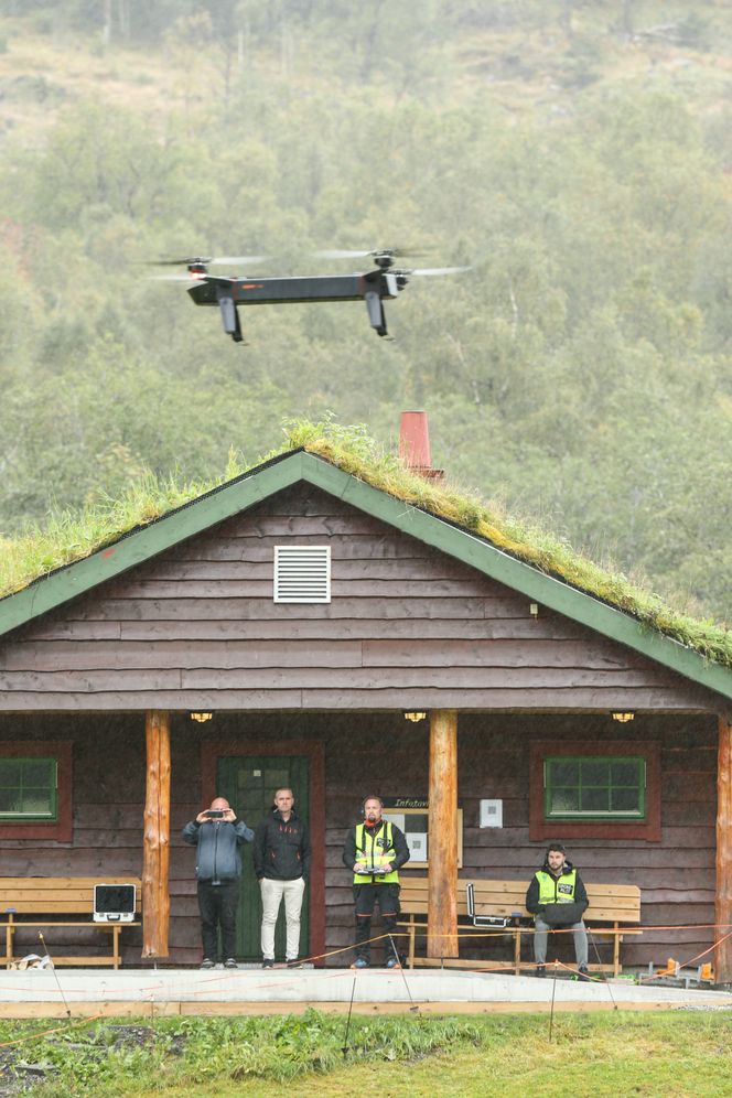 Den kommersielle modellen Griff 135 testes på en fotballbane i Sykkylven mens de venter på å dra ut i verden og vise den til kunder. Det var regn i luften denne dagen, men dronen er bygget for å tåle all slags vær. Fra venstre Jan Martin Nysæter, Odd Einar Hjellen, Marius Strand Ødven og Jesper Madsen. Foto:  Jørn-Arne Tomasgard