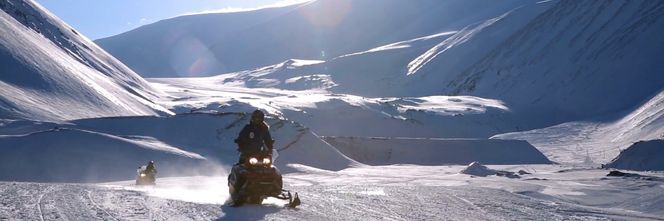 Fartsfylt jobbreise: Kritiske anlegg kan befinne seg langt ut på vidda eller på toppen av et fjell. Derfor er både helikopter og snøskuter typiske fremkomstmiddel. Foto: Adobe Stock