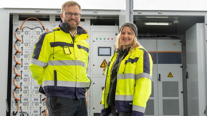 Solcellespesialistens Carl Christian Strømberg og Anne Marte Minge Engh foran et av batterisystemene de har levert. <i>Foto:  TUM Studio</i>
