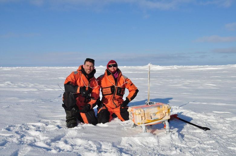 UiT-forskerne Jack Landy og Polona Itkin utplasserer en sjøisbøye for å registrere istykkelsen. <i>Foto:  Christian Zoelly/Norsk polarinstitutt</i>