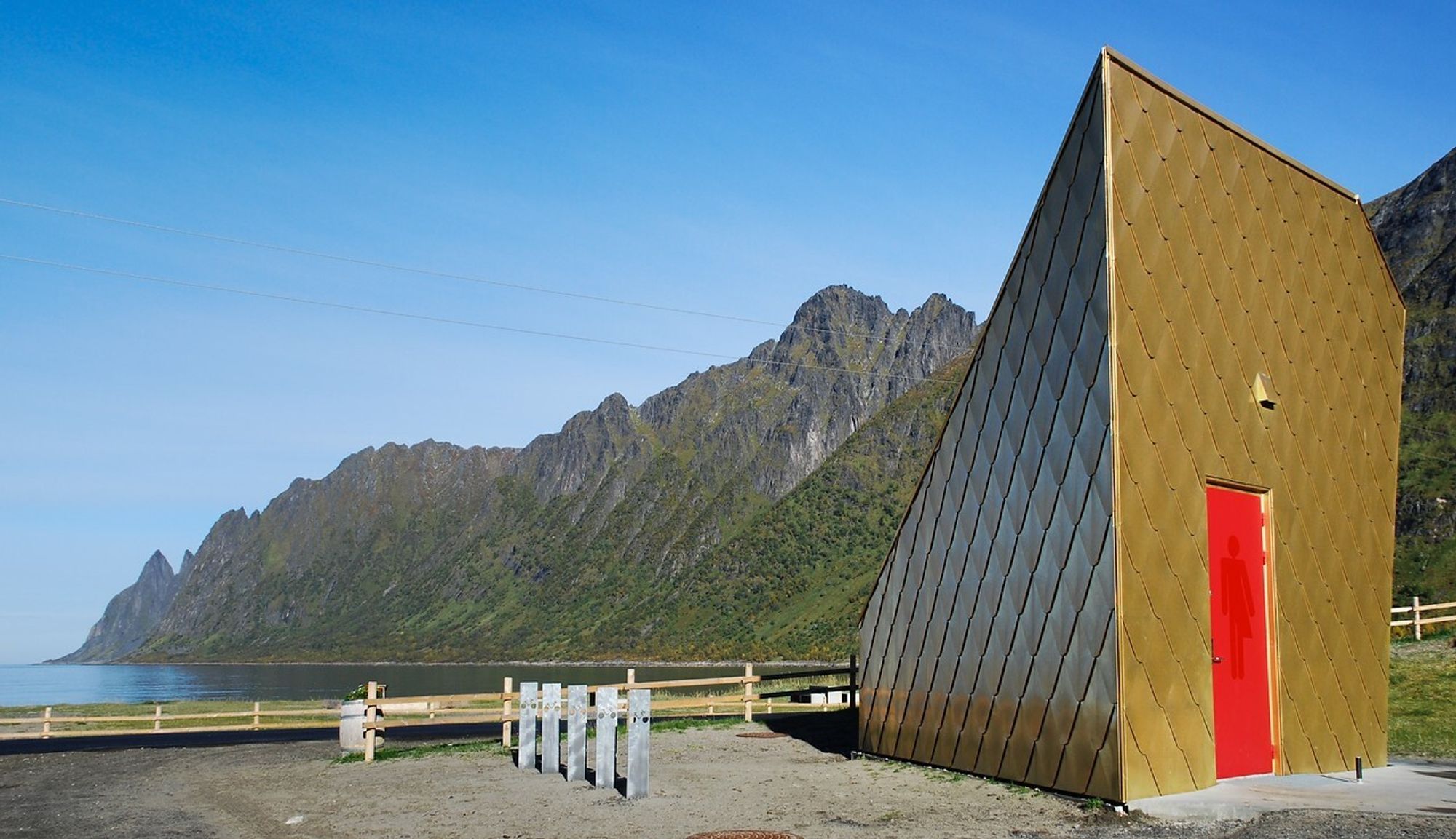 Det 5,5 meter høye toalettbygget ved Ersfjordstranda på Senja har tilnavnet Gulldassen. Arkitekt er Tupelo arkitektur. Okshornan i bakgrunnen.